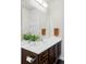 Bright bathroom with white countertop and dark wood cabinets offering ample storage at 6251 N Galena St, Denver, CO 80238