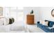 Bright bedroom featuring large windows, a cozy bed, modern furnishings, and a blue velvet couch at 6251 N Galena St, Denver, CO 80238