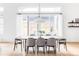 Dining room featuring a large table with seating for eight and modern light fixture and sliding doors to backyard at 6251 N Galena St, Denver, CO 80238