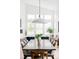 Elegant dining area featuring a large table with seating for eight and an open layout to the living room at 6251 N Galena St, Denver, CO 80238