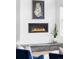 Modern electric fireplace set into a stone hearth and complemented by stylish decor and a houseplant at 6251 N Galena St, Denver, CO 80238
