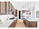 A spacious kitchen with wooden cabinets, stainless steel appliances, and a large island with bar seating at 6251 N Galena St, Denver, CO 80238