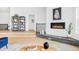 Cozy living room with a modern fireplace and an open floor plan offering a seamless flow to other rooms at 6251 N Galena St, Denver, CO 80238