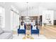 Spacious living room with kitchen and dining area in background, featuring ample natural light and modern design at 6251 N Galena St, Denver, CO 80238