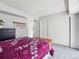 Bedroom featuring a queen-size bed and a closet with sliding doors at 14439 E 1St Dr # C11, Aurora, CO 80011