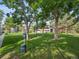 Lush green space with mature trees and pet waste station in a well-maintained community at 14439 E 1St Dr # C11, Aurora, CO 80011
