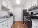 Functional kitchen features white cabinets, stainless steel appliances, and wood-look flooring at 14439 E 1St Dr # C11, Aurora, CO 80011