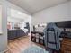Open-concept living room with wood flooring, a fireplace, and a comfortable gray couch at 14439 E 1St Dr # C11, Aurora, CO 80011