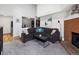 Spacious living room with brick fireplace, plush seating, and neutral decor at 14439 E 1St Dr # C11, Aurora, CO 80011