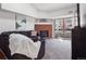 Bright living room featuring a brick fireplace, sliding glass door, and plush gray carpeting at 14439 E 1St Dr # C11, Aurora, CO 80011