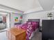 Well-lit bedroom features a comfortable bed, vibrant decor, and access to a private balcony at 14439 E 1St Dr # C11, Aurora, CO 80011
