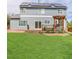 Home exterior featuring a well-kept lawn, deck with pergola, and solar panels on the roof at 9954 Heywood St, Highlands Ranch, CO 80130