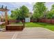 Backyard featuring a large deck, lush green grass, a storage shed and wood fencing at 9954 Heywood St, Highlands Ranch, CO 80130
