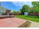 Spacious backyard featuring a deck, patio, grassy area, storage shed, and wood fencing at 9954 Heywood St, Highlands Ranch, CO 80130