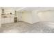 Basement with bar area and large, open carpeted area for entertaining or relaxing at 9954 Heywood St, Highlands Ranch, CO 80130