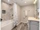 Charming bathroom with tub/shower combo, wood-look floors, and stylish vanity at 9954 Heywood St, Highlands Ranch, CO 80130
