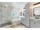Beautiful bathroom with marble tiled walls, separate tub, and glass enclosed shower at 9954 Heywood St, Highlands Ranch, CO 80130
