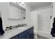 Updated bathroom with a stylish vanity, marble countertop, and subway tile shower at 9954 Heywood St, Highlands Ranch, CO 80130