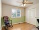 Comfortable bedroom featuring hardwood floors, a ceiling fan, and a spacious closet at 9954 Heywood St, Highlands Ranch, CO 80130