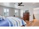 Bedroom featuring a wooden bed frame, neutral walls, and bright windows at 9954 Heywood St, Highlands Ranch, CO 80130