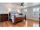 Bedroom featuring wood floors, neutral walls, and two windows at 9954 Heywood St, Highlands Ranch, CO 80130