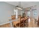 Dining area with hardwood floors, a modern light fixture, and seating for six at 9954 Heywood St, Highlands Ranch, CO 80130