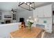 Bright dining room with modern light fixture and adjacent white cabinets and countertop work space at 9954 Heywood St, Highlands Ranch, CO 80130