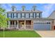 Charming two-story home with a well-manicured lawn and attached two-car garage at 9954 Heywood St, Highlands Ranch, CO 80130