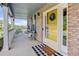 Inviting front porch with brick accents, white pillars, and a 'Welcome Home' doormat at 9954 Heywood St, Highlands Ranch, CO 80130