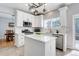 Bright kitchen with white cabinetry, stainless steel appliances, and a central island at 9954 Heywood St, Highlands Ranch, CO 80130
