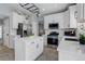 Bright kitchen features white cabinetry, stainless steel appliances, and a functional island at 9954 Heywood St, Highlands Ranch, CO 80130