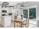 Eat-in kitchen with white cabinets, stainless steel appliances, and backyard access at 9954 Heywood St, Highlands Ranch, CO 80130