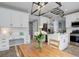 Modern kitchen with white cabinets, stainless steel appliances, and a butcher block island at 9954 Heywood St, Highlands Ranch, CO 80130