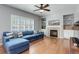 Comfortable living room featuring a fireplace, built-in shelving, and a large window for natural light at 9954 Heywood St, Highlands Ranch, CO 80130