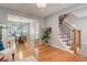 Open living area with hardwood floors, a staircase, and a dining nook in the background at 9954 Heywood St, Highlands Ranch, CO 80130