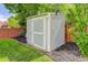 Backyard shed with manicured lawn, garden beds, and tree backdrop at 9954 Heywood St, Highlands Ranch, CO 80130