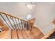 Staircase with wood steps, metal railing, and an overhead light fixture at 9954 Heywood St, Highlands Ranch, CO 80130