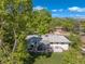Picturesque aerial shot highlighting the property's backyard, deck, and mature trees, providing a sense of privacy at 13402 W 24Th Pl, Golden, CO 80401