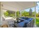 Covered patio with a comfortable seating area and a view of the lush backyard at 13402 W 24Th Pl, Golden, CO 80401