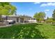 Spacious backyard featuring a well-maintained lawn, patio area, hot tub, and recreational equipment for outdoor enjoyment at 13402 W 24Th Pl, Golden, CO 80401