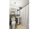 Cozy bathroom with white pedestal sink, wood-look tile floors, and decorative shower curtain at 13402 W 24Th Pl, Golden, CO 80401