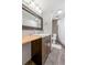 Modern bathroom with brown vanity and a shower area at 13402 W 24Th Pl, Golden, CO 80401