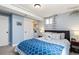 Comfortable bedroom with soft blue walls, with a dark wood headboard at 13402 W 24Th Pl, Golden, CO 80401