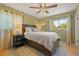 Cozy bedroom with a ceiling fan, ample natural light, and stylish decor at 13402 W 24Th Pl, Golden, CO 80401