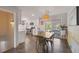 Bright dining area with a stylish light fixture, sliding doors to the backyard, and easy kitchen access at 13402 W 24Th Pl, Golden, CO 80401