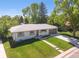 Charming home exterior with a well-manicured lawn, a tidy walkway and driveway, and an attached garage at 13402 W 24Th Pl, Golden, CO 80401