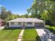 Charming home exterior with a well-manicured lawn, a tidy walkway and driveway, and an attached garage at 13402 W 24Th Pl, Golden, CO 80401