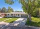 Inviting home with fresh paint, manicured lawn, a driveway, and mature trees, great curb appeal at 13402 W 24Th Pl, Golden, CO 80401