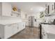 Bright kitchen features white cabinetry, stainless steel appliances, and neutral countertops at 13402 W 24Th Pl, Golden, CO 80401
