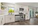 Updated kitchen boasts stainless steel appliances, white cabinets, and a view to the backyard at 13402 W 24Th Pl, Golden, CO 80401